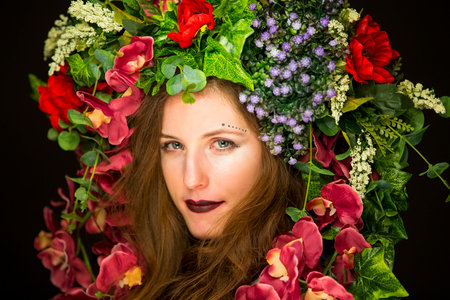 young fairy woman with flowers on her headの写真素材