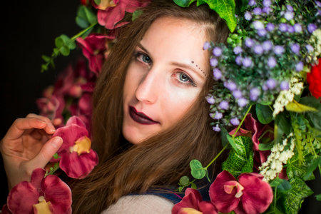 young fairy woman with flowers on her headの写真素材