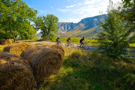 cyclists riding through mountain landscape in Transylvaniaの写真素材