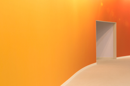 orange wall and open entrance in a empty roomの写真素材