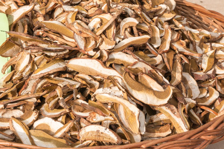 dried mixed porcini mushrooms in wicker bowlの写真素材