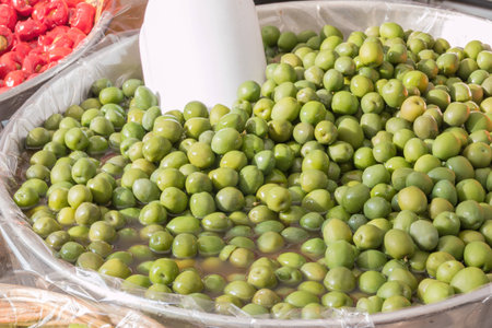 group of natural green olives with red peppersの写真素材