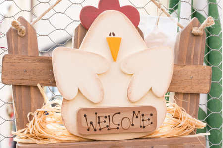 Hanged green home wooden decoration chicken shaped with welcome lettersの写真素材