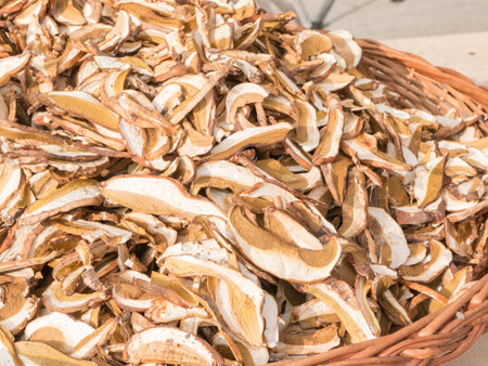 dried mixed porcini mushrooms in wicker bowlの写真素材