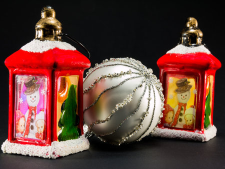 two vintage red lanterns with snowman and children picture and bright christmas ballの写真素材