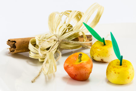red and yellow marzipan apple fruits with cinnamon spicy stickの写真素材