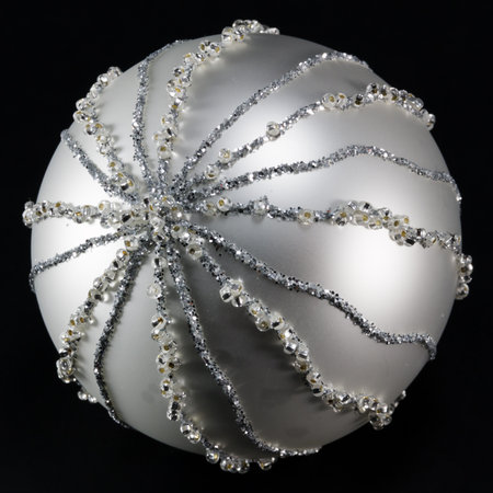 sparkling silvery christmas ball over black backgroundの写真素材