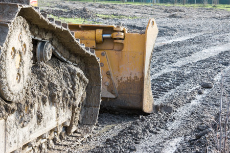 closeup of tracked loader excavator at stony quarry on a building site
