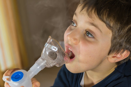 child taking respiratory, inhalation therapyの写真素材