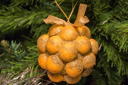 golden bunch decoration on green christmas treeの写真素材