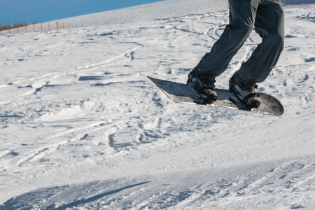 closeup of freestyle snowboarder jumpの写真素材