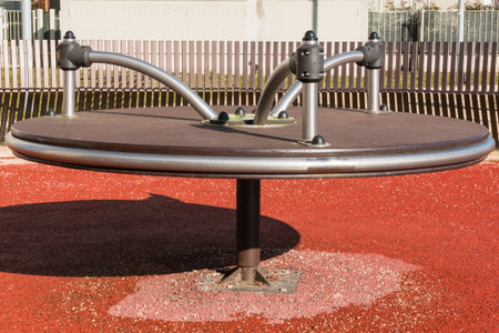Modern metal merry-go-round playground in public park