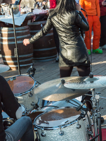 Public music event: drums and woman singer rear viewの写真素材