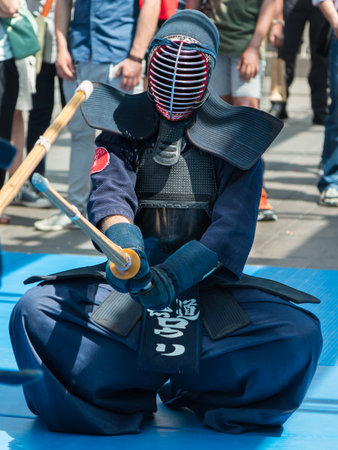 Kendo Fighter on His Knees match in Traditional Clothes and Bamboo Sword, Japanese Martial Artのeditorial素材