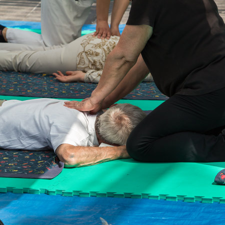 Elderly Man receiving Professional Massage by Therapistの写真素材