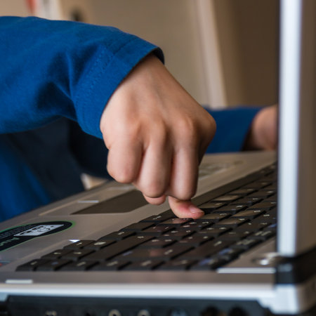 Closeup Child Index Finger on Laptop keyboard, button