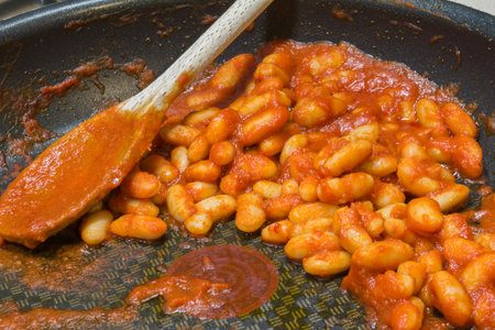 Stew Baked Bean in black Frying Pan with Wooden Spoonの写真素材