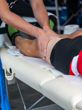 Athlete's Quadriceps Muscle Professional Massage Treatment after Sport Workout, Fitness and Wellnessの写真素材