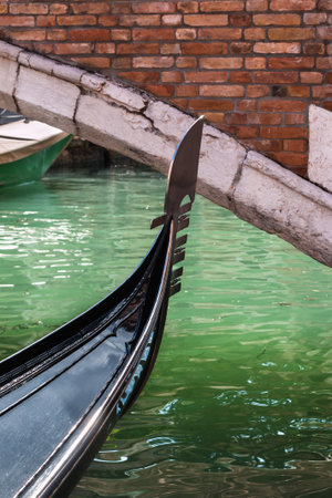 Close up of Gondola's Iron Prow and Antique Bridge in Venice, Italyの写真素材