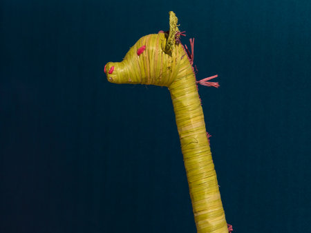 Yellow Wicker Giraffe Decoration Toy on Blue Backgroundの写真素材
