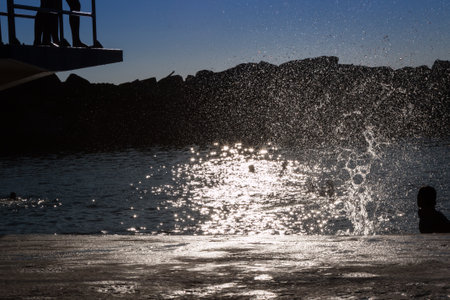 Water Splash: Child Jumping from Board into Water, Summer Funの写真素材