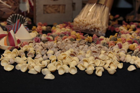 Colorful Italian Uncooked Pasta Assortment on Table, Orecchiette Pugliesiの写真素材