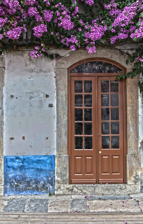 Antique Door near Purple Flowers in the Medieval Portuguese City of Obidosの写真素材