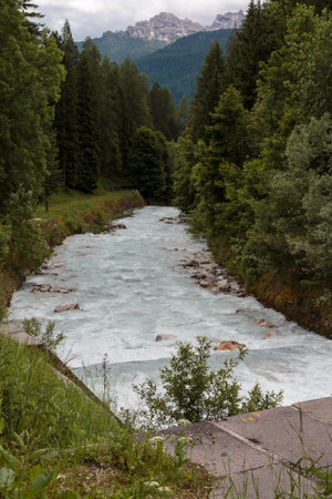 Stream with White Pure Water and Mountains Peaks in backgroundの写真素材