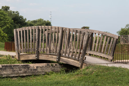 Little Pedestrian Curved Wooden Bridge in a Parkの写真素材