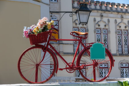 Red Vintage Bicycle with Colorful Flowers in the Basket in Sintra, Portugalの写真素材