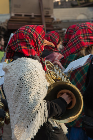 Woman in Red Scottish Kerchief, Shawl and Fake Nose with Gold Brass Hornの写真素材