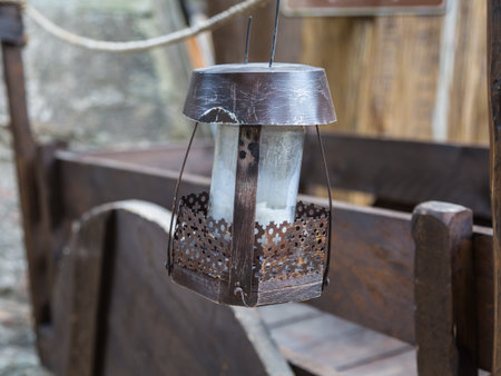 Old Iron Hanged Lamp, Wooden Brown Cart in backgroundの写真素材