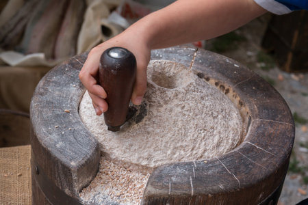 Using an Ancient Manual Stone Millの写真素材