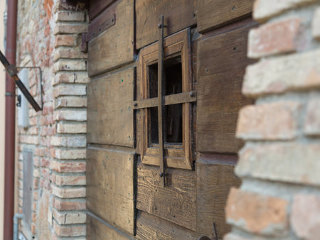 Close-up of Ancient Brown Wooden Door with Openingの写真素材