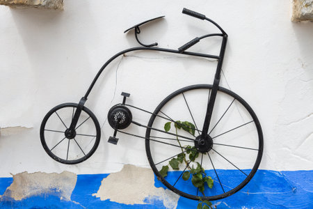 Hstorical Vintage Velocipede Bicycle Hanging on Street Wall.の写真素材