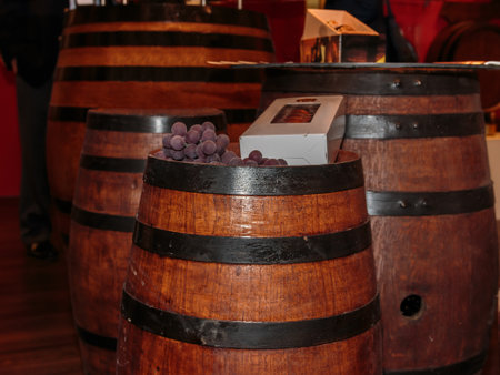 Violet Grapes and White Bottle Box on Fine Big Wine Wooden Barrel
