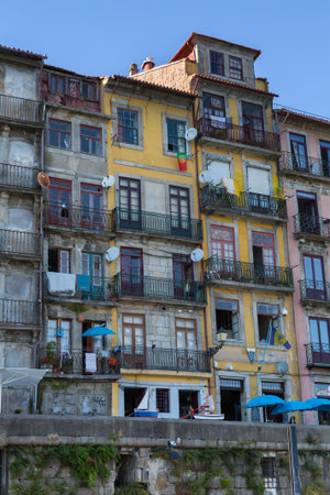 Typical Colorful Portuguese Architecture: Tile Azulejos Facade with Antique Windows And Balcony - Portugal.のeditorial素材
