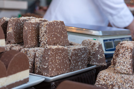 Dark Chocolate Slices with Crumbled Nuts on a Tray.の写真素材