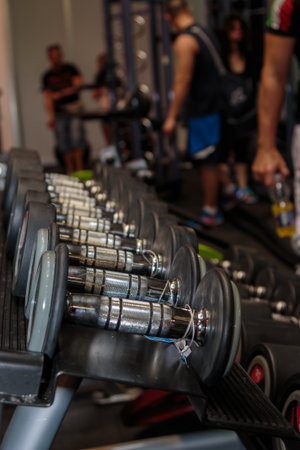 Black and Steel Dumbbells in Gym: Weight Fitness Equipment.