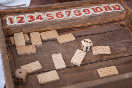 Antique Table Game with Dices and Rectangular Wooden Pieces on Board.の写真素材
