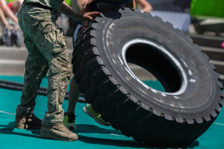 Soldiers Lift Huge and Heavy Truck Tire.の写真素材