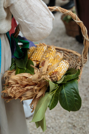 Countrywoman with Yellow Corns inside Wicker Basket, Cobsの写真素材
