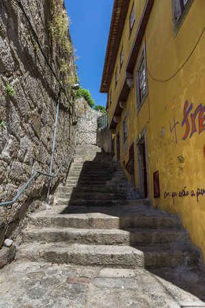 Old Narrow Street with Stairs in Portuguese Cityの写真素材