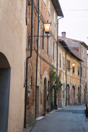 Narrow Street in Italian Village: Houses with Stone Facade and Lamps.の写真素材