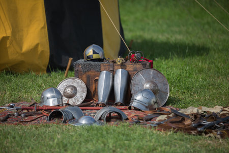 Helmets, Shields and Medieval Metallic Armors and Weapons, Outdoors near Tent.の写真素材