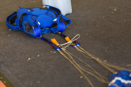 Blue Parachute Folded Up on the Ground.