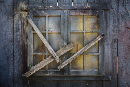 Closed Wooden Window Barred with Wooden Planks.