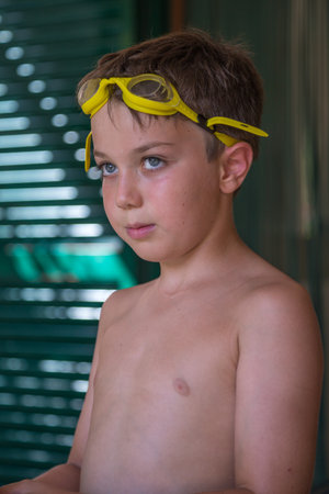 Boy with Yellow Pool Goggles Ready to Swim: Summertime Concept.の写真素材