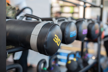 Black Leather Sacks and Dumbbells in Gym: Weight Fitness Equipment.