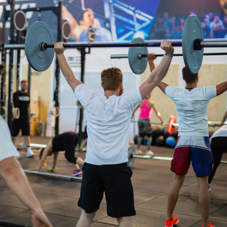 Caucasian Young Male with Muscular Body Lifting Weights in Gym.のeditorial素材